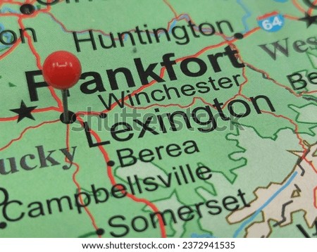 Round red tack on map of Lexington, Kentucky.  This city is the county seat of Fayette County, KY. Royalty-Free Stock Photo #2372941535