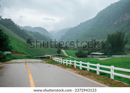 Ban Mae Konken, Mae Sot, Thailand- October 8th 2023 : Border mountain of Thailand and Myanmar separated by a river- during raining season and rainy cloud. 