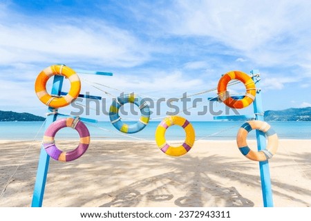 Artificial swim ring rubber on the beach with blue sky in summer.