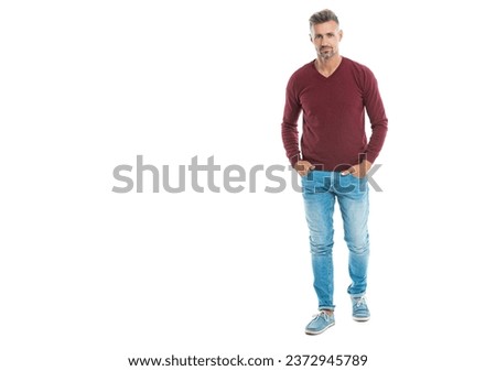 a caucasian man in his 40s at studio background with copy space banner. good looking caucasian man stands. full length of a handsome caucasian man isolated on white. A Caucasian man wearing pullover Royalty-Free Stock Photo #2372945789