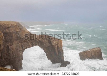 The Green bridge of Wales on the Pembrokeshire coast UK during storm Agnes Royalty-Free Stock Photo #2372946803