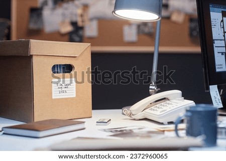 Close up of file box and landline phone on desk in detectives office, copy space
