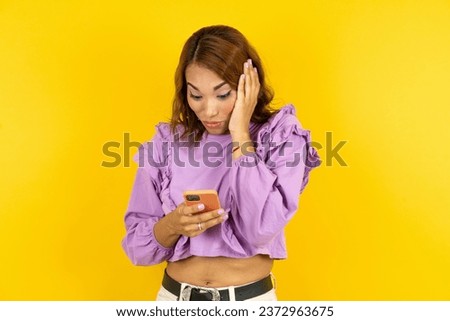 Young beautiful woman holding in hands cell reading sms using new app 5g