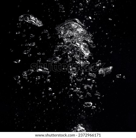 Many air bubbles in water on black background