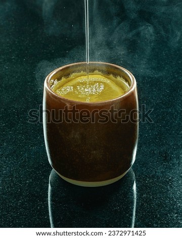 Hot lemon tea placed on a black marble table 