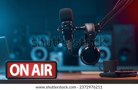 Radio broadcasting station professional equipment and On Air light sign in the foreground