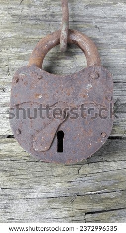 Old lock. Old padlock on a wooden background. Vintage photo