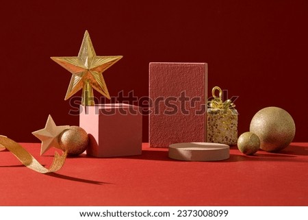 Background for the presentation of cosmetic products with Christmas concept. Front view of empty podiums decorated with cute yellow decorative accessory on red background