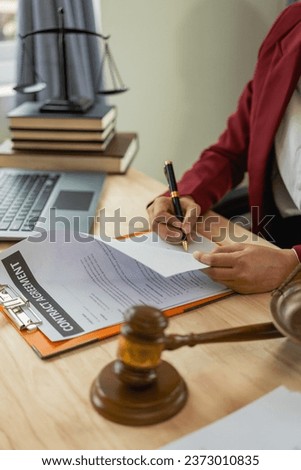 Female lawyer working with perch and scales in law office Close-up pictures