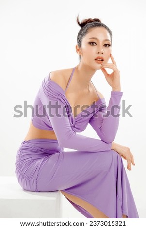 Fashionable Asian woman have good figure and clear fresh skin in purple trendy dress pose on isolated white background. Plastic Surgery, Concept of beauty, body and skin care, health, spa, cosmetics.