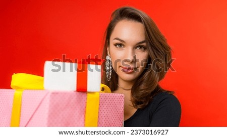 young bright brunette woman with earrings made gifts for herself to enslave herself.