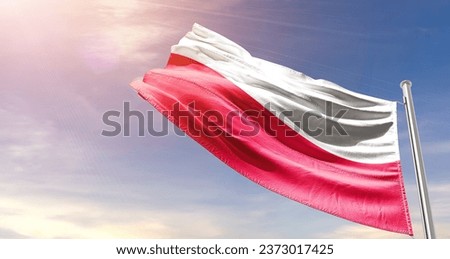 Poland national flag waving in beautiful sky. The flag waving with dynamic angle. Royalty-Free Stock Photo #2373017425
