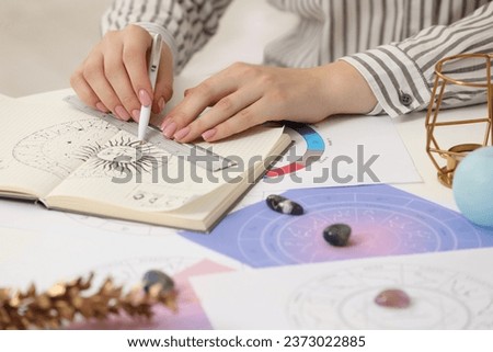 Astrologer using zodiac wheel for fate forecast at table, closeup. Fortune telling Royalty-Free Stock Photo #2373022885
