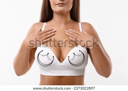 Breast surgery. Woman with markings on bra against white background, closeup Royalty-Free Stock Photo #2373022897