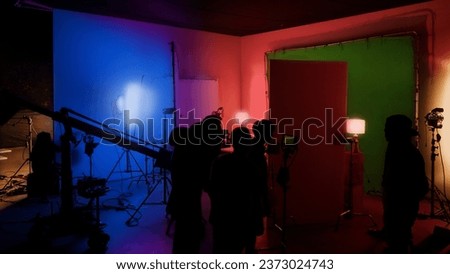 Silhouette images of making of or behind the scenes of video production which produced in the film studio that include all pro light and camera equipment and professional film crew with movie director