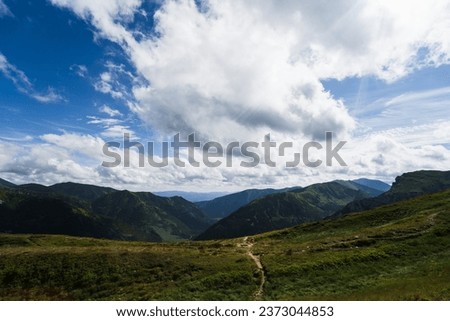 Mountain landscape in the Polish Tatras. The sky is overcast with cumulus clouds. High quality photo