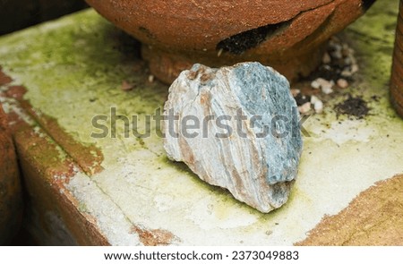 a rock in a pot.