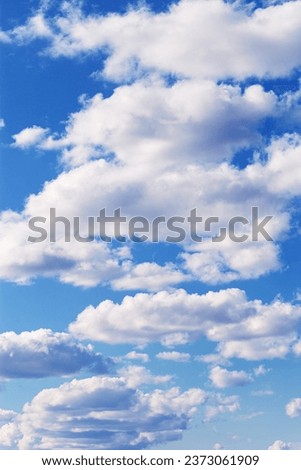 Blue sky with white clouds, bright colored cloudscape. Fluffy heaven pattern, aesthetic natural scene. Beautiful Cloudy background, nature environment backdrop, wallpaper, phone screensaver