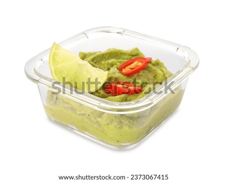 Bowl of delicious guacamole with chili pepper and lime isolated on white