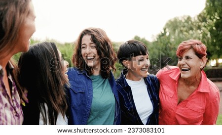 Multi-generation group of people having fun at city park - Happy women from different ages celebrating outdoors Royalty-Free Stock Photo #2373083101
