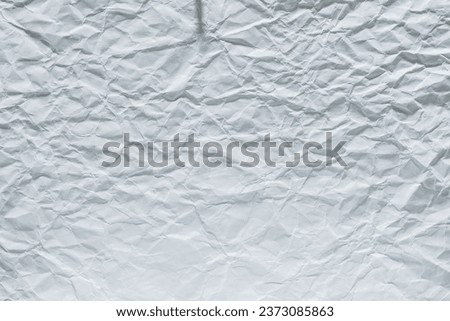 Crumpled white paper sheet texture.