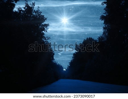 Bright star over the forest and road. Christmas star of the Nativity of Bethlehem, Nativity of Jesus Christ.