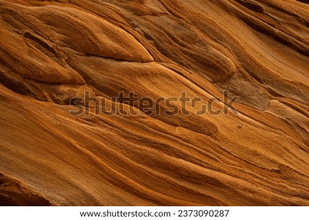 Full frame of sandstone rock pattern, Rock formation, natural of sand stone on beach in Australia, line and curve of stone use for background Royalty-Free Stock Photo #2373090287