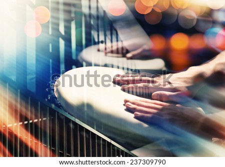 Street music background. Hands on percussion, abstract urban details and lights Royalty-Free Stock Photo #237309790