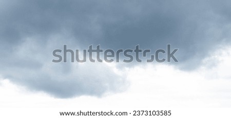 Autumn brings overcast skies adorned with gray stratus clouds, hinting at impending rain. This full-screen view provides ample space for text or design elements, making it perfect for various projects Royalty-Free Stock Photo #2373103585
