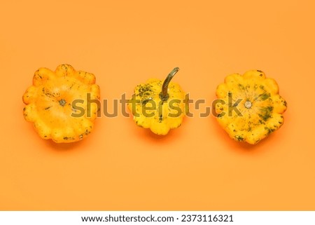 Fresh pumpkins on orange background