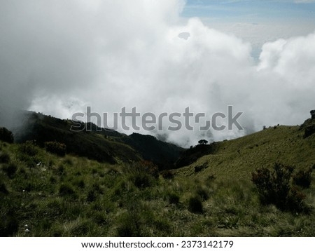 Valley shrouded in clouds on the Mount Merbabu climbing route via Selo, Central Java, Indonesia