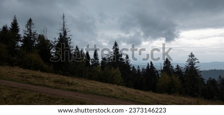 Dramatic lead cumulus and stratus clouds over the mountains of the Ukrainian Carpathians near the village of Slavske in the Lviv region. Cloudy autumn day.