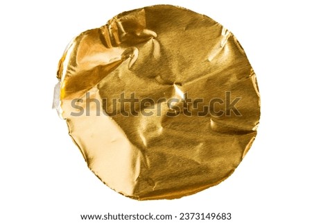 Round piece of golden metallic paper isolated on white background