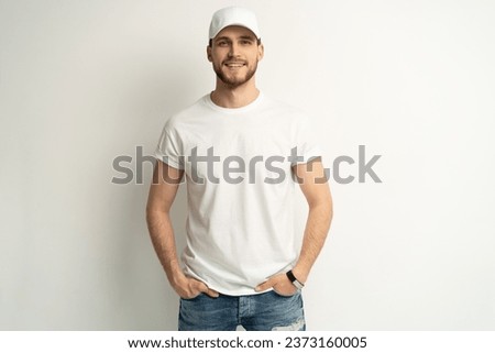 Handsome man wearing blank white cap and white t-shirt isolated on white background Royalty-Free Stock Photo #2373160005