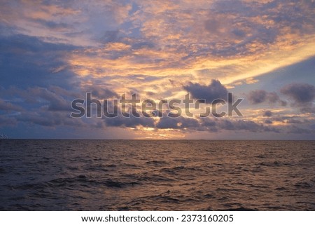 The sea and sky on a cloudy day when the sun is about to set