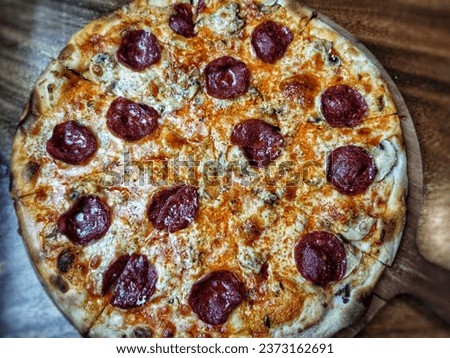 Picture of an authentic pizza with pepperoni and melted mozzarella, oozing with deliciousness