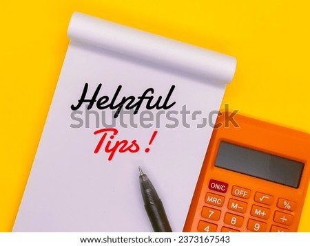 Notebooks, pencils and pens with the concept of the words "Helpful Tips!" yellow background.