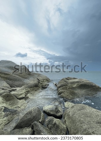 Rocks and Sea against cloudy sky