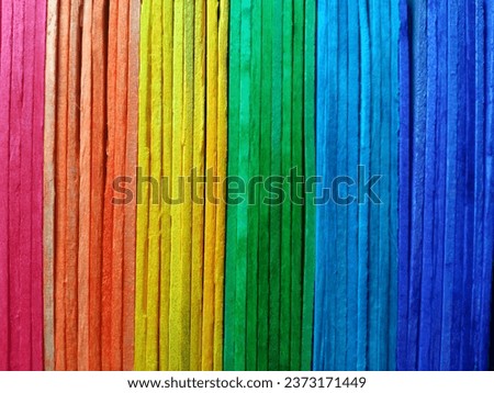 vertical rainbow pattern plank wall background texture for design or stock photo, colourful wooden, pink orange yellow green blue colors 