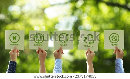A group of businessmen's hands holding a brown recycled paper card with 5R sign and icon. Recycle, Reuse, Reduce, Refuse, and Repair for zero waste movement and technology ecology care. Royalty-Free Stock Photo #2373174053