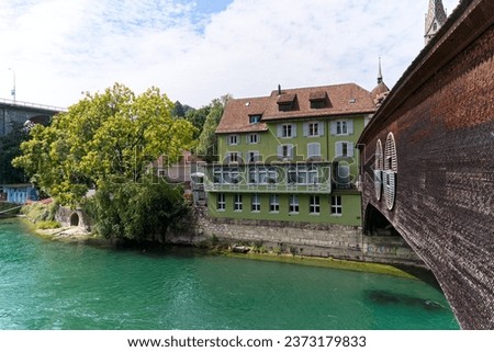 Scenic view of the old town of Swiss City of Baden with covered wooden bridge over Limmat River on a sunny summer day. Photo taken August 19th, 2023, Baden, Switzerland.