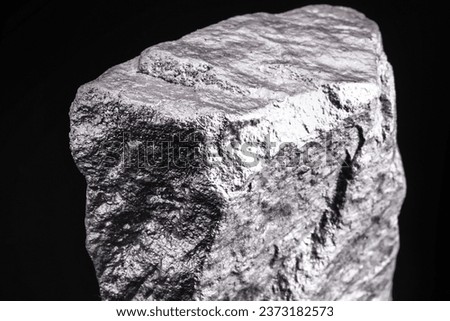 Raw manganese. Manganese stone isolated on black background. Mineral extraction of heavy metals.