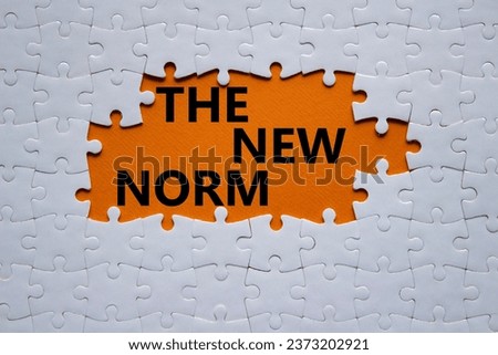The new norm symbol. Concept words The new norm on white puzzle. Beautiful orange background. Business and The new norm concept. Copy space. Royalty-Free Stock Photo #2373202921