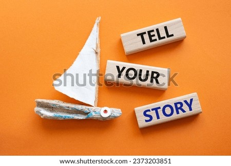 Tell your story symbol. Wooden blocks with words Tell your story. Beautiful orange background with boat. Business and Tell your story concept. Copy space.
