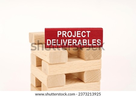 Business concept. On the wooden planks there is a red one with the inscription - Project deliverables Royalty-Free Stock Photo #2373213925