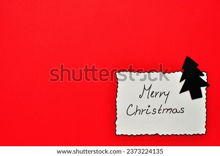 minimalistic red merry christmas background - card next to tree 