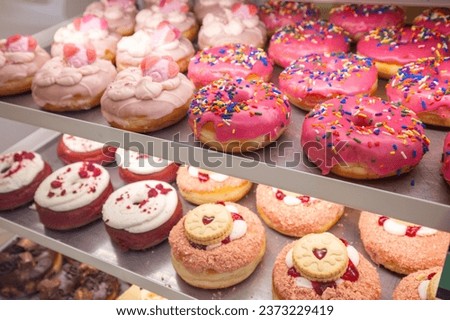 Delicious donuts on store shelves closeup. London, UK Royalty-Free Stock Photo #2373229419
