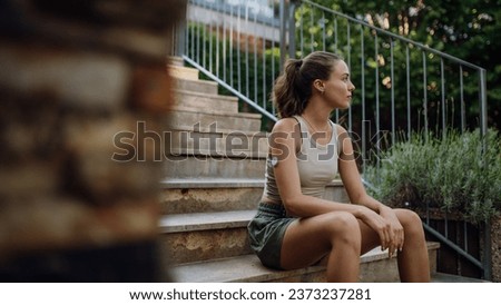 Diabetic woman preparing for outdoor run in the city. Young woman wearing continuous glucose monitor during exercising. Concept of exercise and diabetes. Banner with copy space. Royalty-Free Stock Photo #2373237281