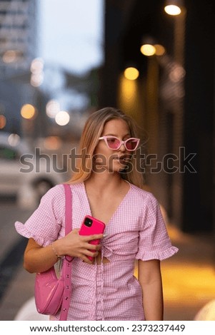 Gen Z girl in pink outfit before going the cinema to watch movie. The young zoomer girl watched movie addressing the topic of women, her position in world, and body image.