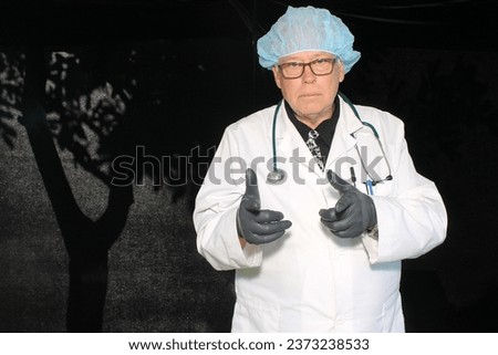 Photo Booth. Photo Booth Pictures. Halloween Party Photo Booth. Costume Party Photo Booth. A Doctor smiles and poses as he waits for his pictures to be taken. Halloween is the time to play Doctor. Fun